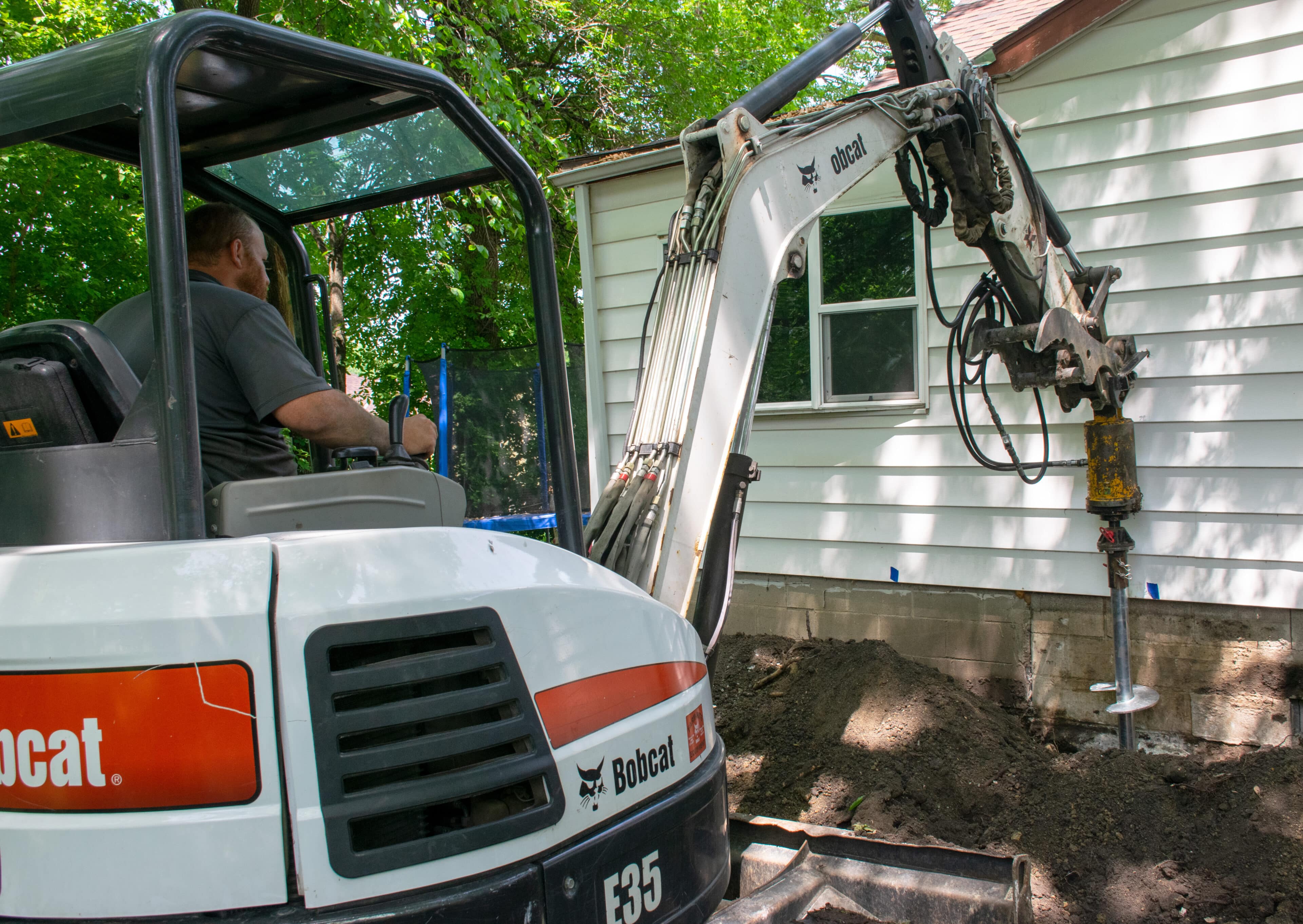 SafeBasements crew installing foundation repair equipment at Minnesota residential property