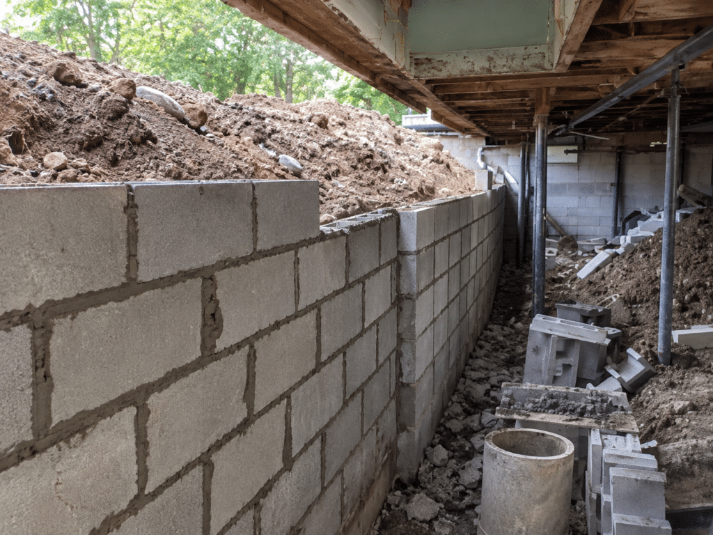 Rebuilding a block foundation wall.